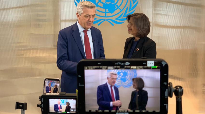 One UN official interviews another in front of the cameras. 